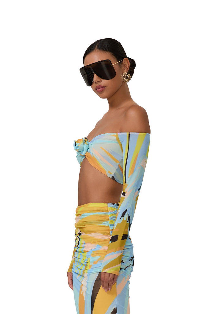 women's crop top with a plunging neck with a front ruched detail and a rose in bird of paradise print